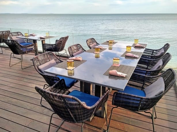 Table set with wine glasses overlooking the water