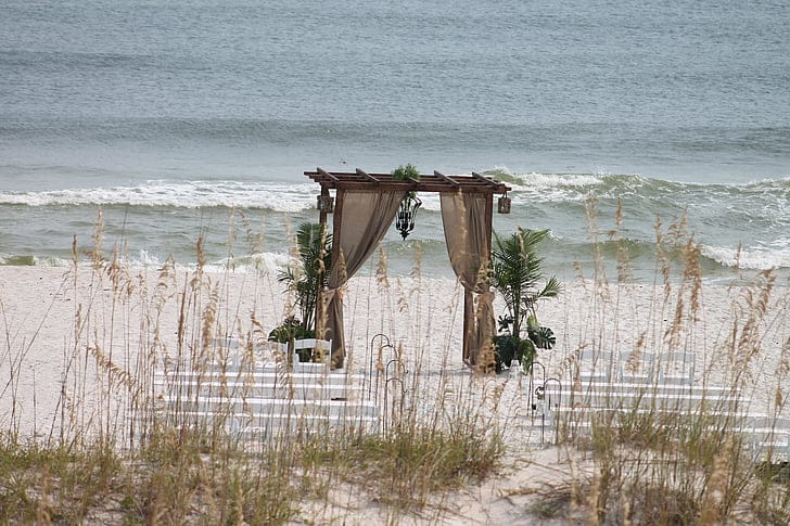 Floral wedding chairs on the sand